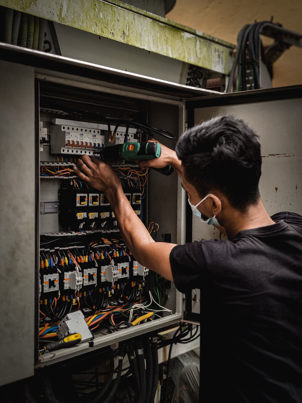 An electrician documenting a home's electrical panel